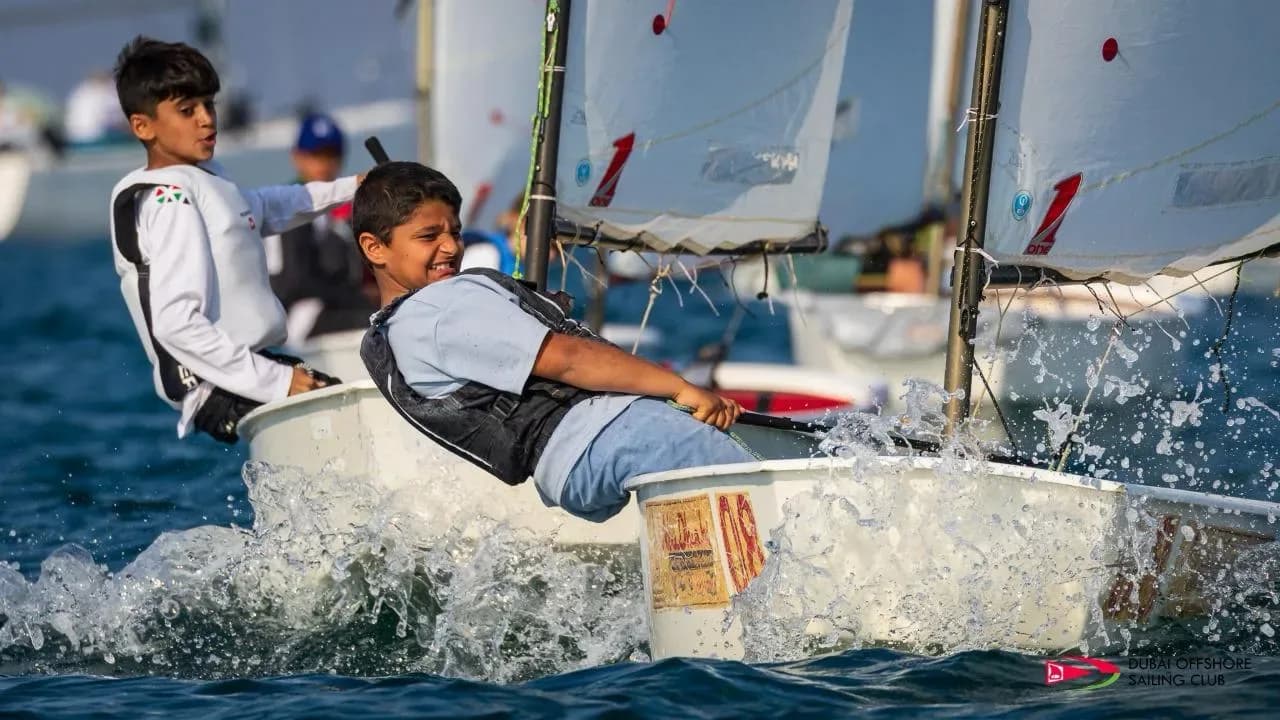 Youth sailors hiking out in a breeze
