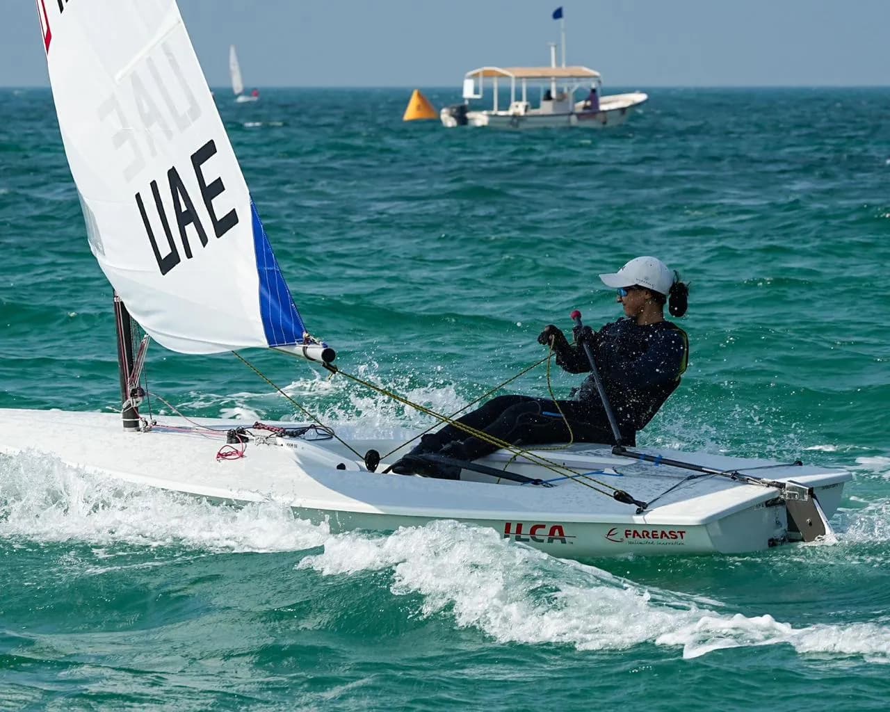 A UAE sailor hiking out of an ILCA dinghy